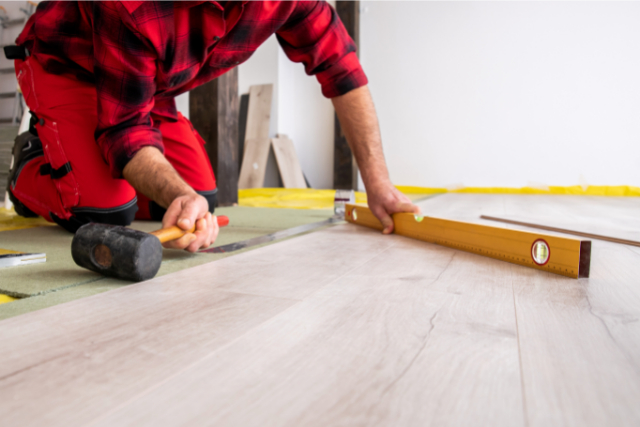 Stamford Worker Installing laminate flooring