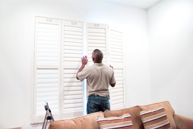 Stamford Window treatment installer installs wooden shutters